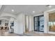 Stunning foyer with black grid door and seamless entry to the kitchen, creating an inviting flow throughout the home at 9408 Players Canyon Ct, Las Vegas, NV 89144