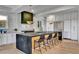 Modern kitchen with large island and white cabinetry at 9408 Players Canyon Ct, Las Vegas, NV 89144