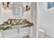 Chic powder room with a green marble vanity and decorative sconces at 9408 Players Canyon Ct, Las Vegas, NV 89144