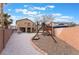 Large backyard with playset, basketball court, and gravel landscaping at 9528 Chanticleer Ct, Las Vegas, NV 89129