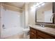 Bright bathroom features a shower-tub combo and granite-topped vanity at 10233 King Henry Ave # 203, Las Vegas, NV 89144