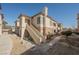 Exterior view of a two-story condo with desert landscaping and stair access at 10233 King Henry Ave # 203, Las Vegas, NV 89144