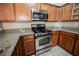 Close up of the kitchen showcasing stainless steel appliances and granite counters at 10233 King Henry Ave # 203, Las Vegas, NV 89144