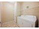 Functional laundry room with a washer, dryer, and shelving for storage at 10233 King Henry Ave # 203, Las Vegas, NV 89144