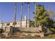 Exterior view of the Carlisle community signage with tall palm trees at 10233 King Henry Ave # 203, Las Vegas, NV 89144