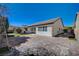 Spacious backyard featuring lush green grass, a brick paved patio, and a covered outdoor space at 11268 Lavandou Dr, Las Vegas, NV 89141