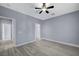 Bedroom boasts a ceiling fan, gray walls, white trim, and light-colored floors at 11268 Lavandou Dr, Las Vegas, NV 89141