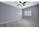 Bedroom boasts a ceiling fan, gray walls, white trim, and plenty of natural light at 11268 Lavandou Dr, Las Vegas, NV 89141