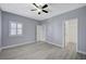 Bedroom boasts a ceiling fan, gray walls, white trim, and light-colored floors at 11268 Lavandou Dr, Las Vegas, NV 89141