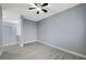 A gray bedroom offering wood-look floors, a ceiling fan, and seamless access to additional rooms at 11268 Lavandou Dr, Las Vegas, NV 89141