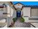 Inviting front entrance featuring a brick walkway leading to a dark blue double door at 11268 Lavandou Dr, Las Vegas, NV 89141