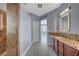 Spacious bathroom with double sinks, granite counters, framed mirrors, and entry to shower and closet at 11268 Lavandou Dr, Las Vegas, NV 89141