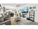 Open living room featuring modern decor, a comfortable gray sofa, and a view into the kitchen and dining area at 1134 Edel Hest Ave, North Las Vegas, NV 89081