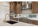 Modern kitchen with a gold faucet and stainless steel range at 144 Stone Mesa Ct, Henderson, NV 89011