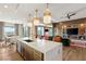 Modern kitchen with wood cabinets, quartz countertops and island seating at 144 Stone Mesa Ct, Henderson, NV 89011