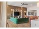 Spacious living room featuring a green sectional sofa and built-in shelving at 144 Stone Mesa Ct, Henderson, NV 89011