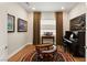 Music room featuring a piano, artwork, and a cozy sitting area at 144 Stone Mesa Ct, Henderson, NV 89011