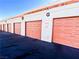 Row of attached garages with light peach doors at 1800 Edmond St # 132, Las Vegas, NV 89146