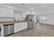 Modern kitchen with white cabinets, stainless steel appliances, and granite countertops at 2136 Chertsey Dr # A, Las Vegas, NV 89108