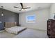 Modern bedroom with geometric wallpaper, fan, and light wood-grain floors at 2280 S Pampa Ave, Pahrump, NV 89048