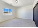 Bright bedroom with carpet flooring, a window, a sliding closet door, and ample natural light at 2280 S Pampa Ave, Pahrump, NV 89048