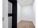 Walk-in closet with minimalist design, a modern door, wood-look flooring, and a bright interior at 2280 S Pampa Ave, Pahrump, NV 89048