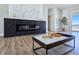 Modern living room fireplace with black tile surround and wood-grain floors at 2280 S Pampa Ave, Pahrump, NV 89048