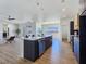Open-concept kitchen features an island with sink, stainless steel appliances, and pendant lighting at 2280 S Pampa Ave, Pahrump, NV 89048