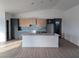 Stylish kitchen with an island, modern gray and wood cabinets, and stainless steel appliances at 2280 S Pampa Ave, Pahrump, NV 89048