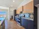 Modern kitchen boasts stainless steel appliances, stylish blue backsplash, and sleek two-tone cabinetry at 2280 S Pampa Ave, Pahrump, NV 89048