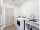 Functional laundry room featuring modern appliances, a utility sink, and a neutral color scheme at 2280 S Pampa Ave, Pahrump, NV 89048