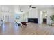 Open-concept living room boasts a modern fireplace, wood-grain floors, and abundant natural light at 2280 S Pampa Ave, Pahrump, NV 89048
