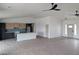 Open-concept living room showcasing a kitchen with modern cabinets, stainless steel appliances, and ample natural light at 2280 S Pampa Ave, Pahrump, NV 89048