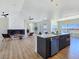 Open-concept living space with modern kitchen, fireplace, and expansive windows offering picturesque views at 2280 S Pampa Ave, Pahrump, NV 89048