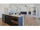 Open-concept living area with modern kitchen, fireplace feature, and natural light flooding the space at 2280 S Pampa Ave, Pahrump, NV 89048