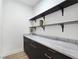 Walk-in pantry features marble countertops, dark cabinets, and open shelving for ample storage space at 2280 S Pampa Ave, Pahrump, NV 89048