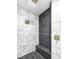 Modern shower with marble and dark stone accent tiles and a built-in bench at 2280 S Pampa Ave, Pahrump, NV 89048