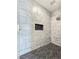 Modern shower boasts white marble tiles, black accent niche, and modern fixtures at 2280 S Pampa Ave, Pahrump, NV 89048