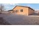 House's backyard with covered patio and gravel at 2595 Fountain Ave, Pahrump, NV 89048