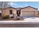 Single-story house with tan exterior, tile roof, and two-car garage at 2595 Fountain Ave, Pahrump, NV 89048