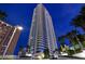 Modern high-rise exterior view with palm trees and well-lit surroundings at 2700 Las Vegas Blvd # 3105, Las Vegas, NV 89109