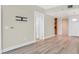 Apartment hallway with hardwood floors leads to an open space, showcasing the thermostat and lighting controls at 2700 Las Vegas Blvd # 3105, Las Vegas, NV 89109