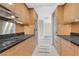 Galley kitchen with black granite countertops, stainless steel appliances, and light wood cabinets at 2700 Las Vegas Blvd # 3105, Las Vegas, NV 89109