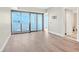 Open-concept living space with access to the balcony, featuring wood floors and a doorway to another room at 2700 Las Vegas Blvd # 3105, Las Vegas, NV 89109