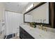 Modern bathroom featuring dual sinks, decorative mirrors, and elegant gold fixtures at 3324 Canyon Lake Dr, Las Vegas, NV 89117