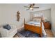 Well-lit bedroom with a cozy chair, wood-look floors, and a comfortable bed at 3324 Canyon Lake Dr, Las Vegas, NV 89117