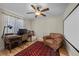 Comfortable bedroom featuring a ceiling fan, work space, and a comfortable leather chair at 3324 Canyon Lake Dr, Las Vegas, NV 89117