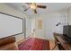 Cozy bedroom featuring a ceiling fan, work space and a comfortable leather chair at 3324 Canyon Lake Dr, Las Vegas, NV 89117