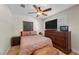 Well-lit bedroom with dresser, mounted TV, and wooden floors at 3324 Canyon Lake Dr, Las Vegas, NV 89117