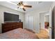 Bedroom featuring a large TV, dresser, and wood-look floors at 3324 Canyon Lake Dr, Las Vegas, NV 89117